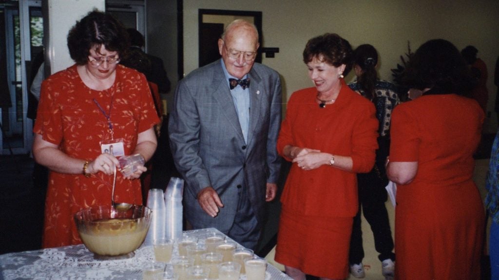 Photo of reception on the "Dance Floor" with Janet Heath pouring punch with William E. Laupus, MD
