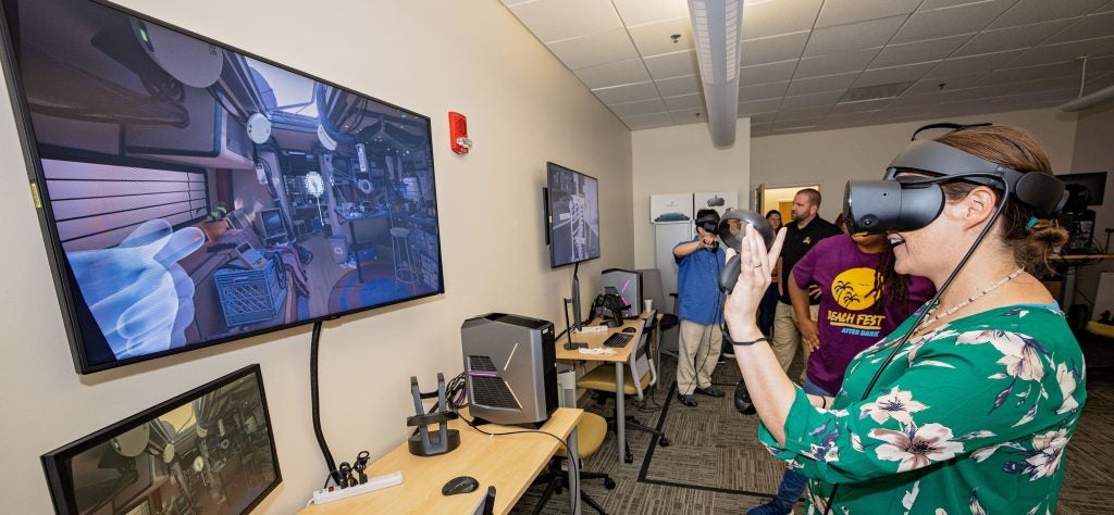 Image of Marlena Rose using a VR headset in the Virtual Reality Lab at Laupus Library