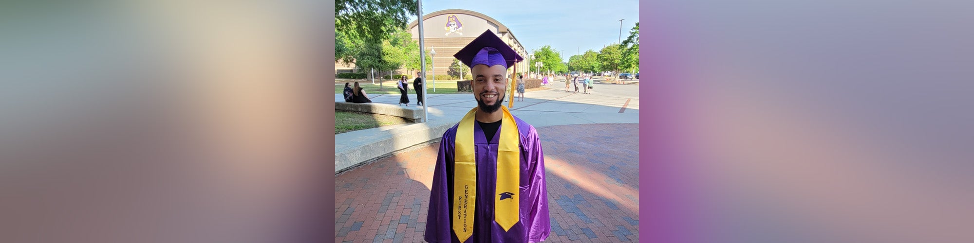 Student in ECU purple graduation robe